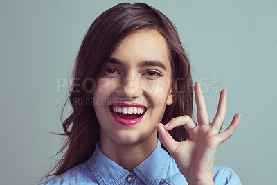 Buy stock photo Portrait, perfect and woman with hand sign in agreement, opinion or like emoji in studio mockup. Happy, review and gen z girl with ok gesture for approval vote, support or yes icon on grey background