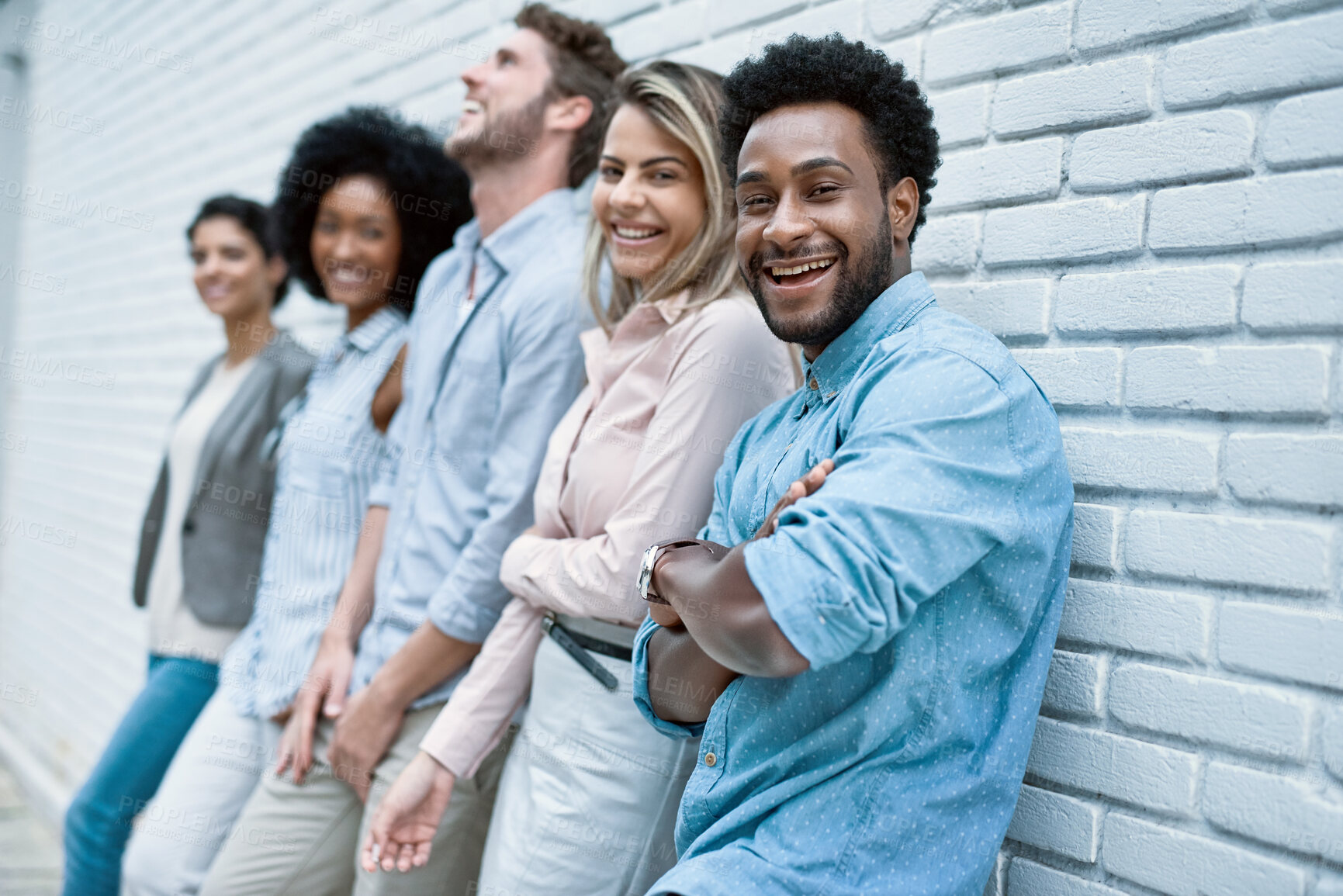 Buy stock photo Business, people and happy in brick wall on row outdoor for teamwork and collaboration as copy writers. Employees, diversity and outside with smile for career growth and job opportunity with unity