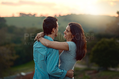 Buy stock photo Happy couple, hug and and sunset with love in nature for romance, getaway or sightseeing in countryside. Young, man and woman with smile in relationship for romantic view, outdoor date or embrace