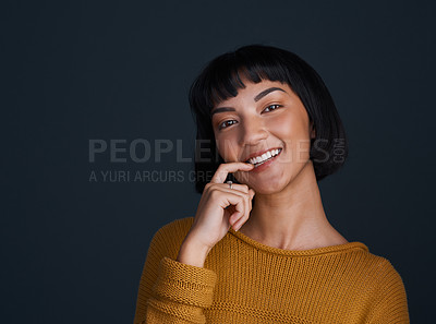 Buy stock photo Portrait, woman and biting finger in studio for flirting, sensual romance and playful with confidence. Girl, beauty and passion emotion for love, seductive gesture and desire on dark background