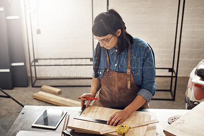 Buy stock photo Cropped shot of an attractive young woman working in her creative workshop