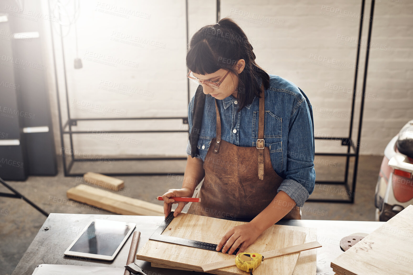 Buy stock photo Cropped shot of an attractive young woman working in her creative workshop