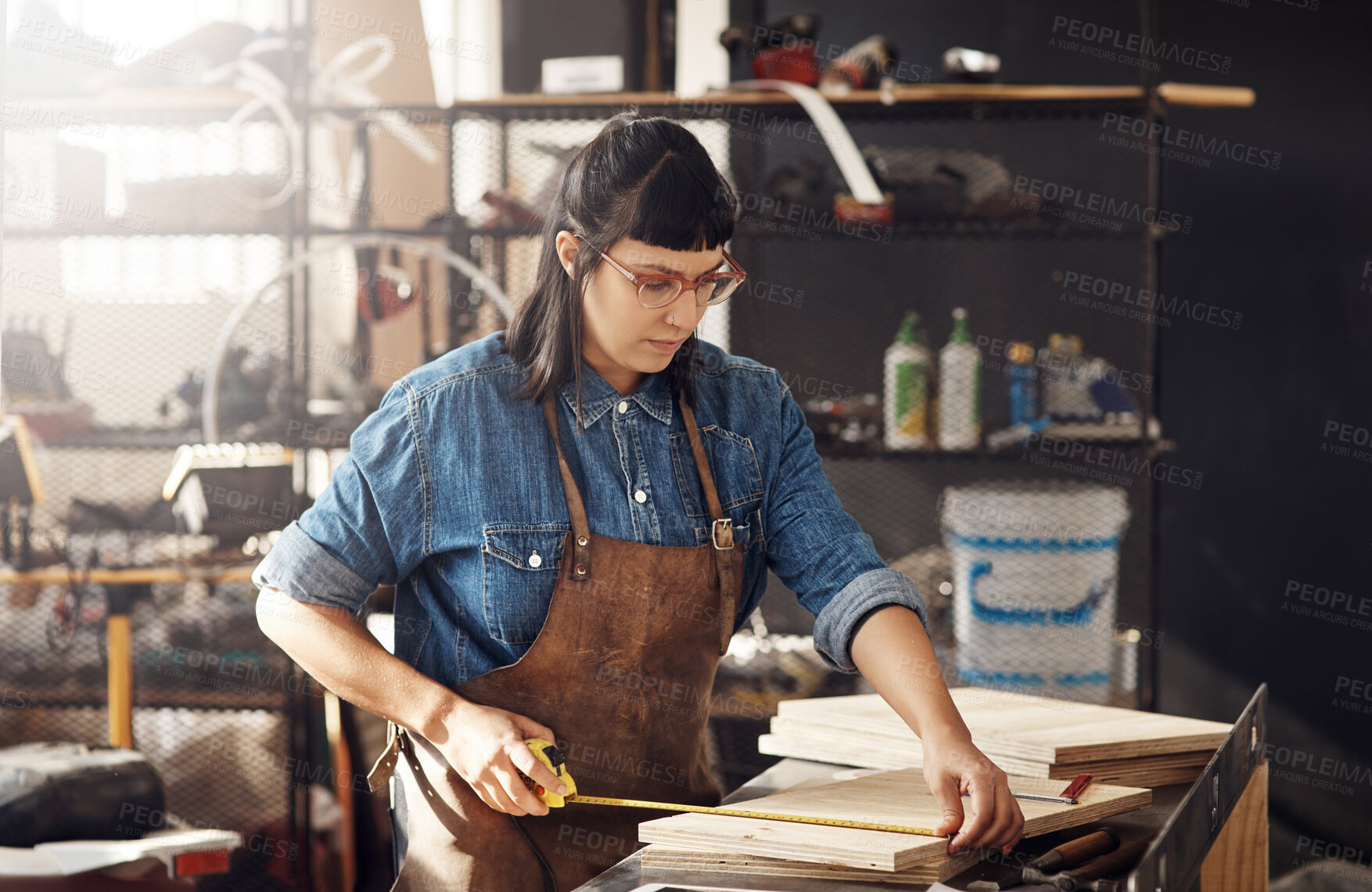 Buy stock photo Cropped shot of an attractive young woman working in her creative workshop