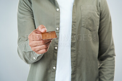 Buy stock photo Hand, studio and holding credit card for payment offer isolated on white background. Debit, closeup and person giving money for financial transaction, bank account and purchase subscription service