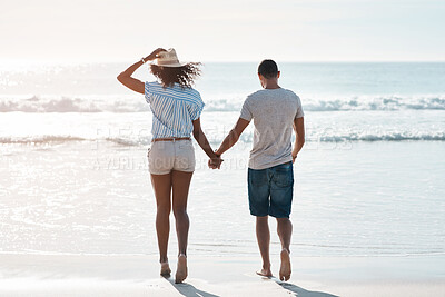 Buy stock photo Walk, back and holding hands with couple love, beach and happy relationship for anniversary on holiday together. Romance, African man and woman for ocean, break and bonding with sunset on vacation