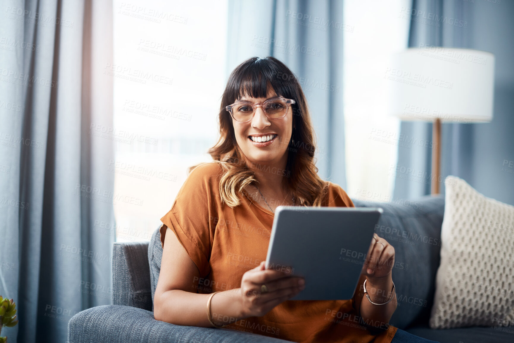 Buy stock photo Woman, tablet and portrait on sofa for movie streaming, relax and social media with communication. Female person, technology and happy on couch for film, subscription and online shopping in house