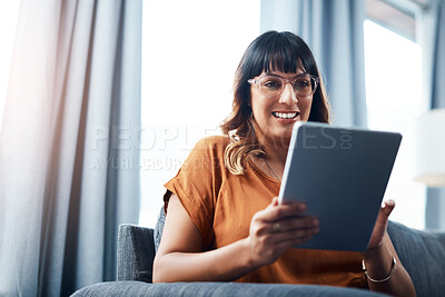 Buy stock photo Woman, tablet and smile on sofa for movie streaming, relax and social media with communication. Female person, technology and happy on couch for film, app subscription and online shopping in house