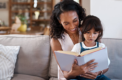 Buy stock photo Smile, mother and child reading book in family home for learning together, education or knowledge. Kid, happy mom and storytelling for fantasy fairytale, magic or literature with foster girl on sofa