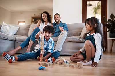 Buy stock photo Kids, building blocks and tower in home, learning and siblings bonding together on lounge floor. Children, brother and sister for educational toys, parents watching and love for mind development