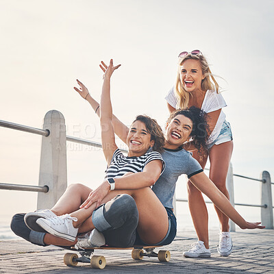 Buy stock photo Beach, promenade and women with skateboard, girls and playful with happiness, getaway trip and excited. People, seaside and friends skating, activity and hobby with summer holiday, vacation or travel