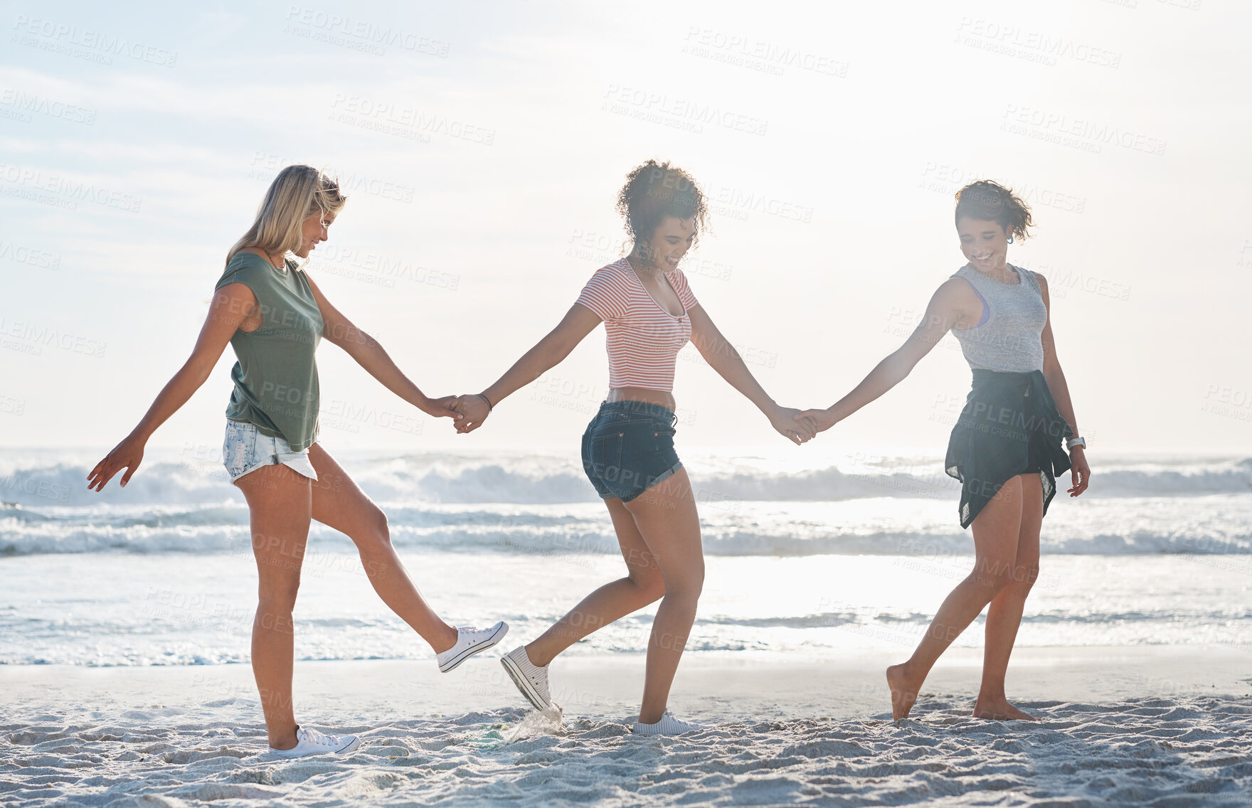 Buy stock photo Happy, friends and holding hands or playful at beach for summer vacation, travel game and bonding reunion. Excited, women and fun with support of holiday adventure, care together and blue sky outdoor