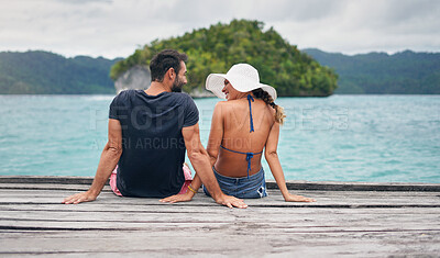 Buy stock photo Back, couple and vacation together on ocean deck, dock or sitting on boardwalk to relax or enjoy the sea or water landscape. People, man and woman on holiday, summer travel or date in tropical nature