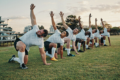 Buy stock photo Cropped shot of a group of young rugby players training on the field during the day