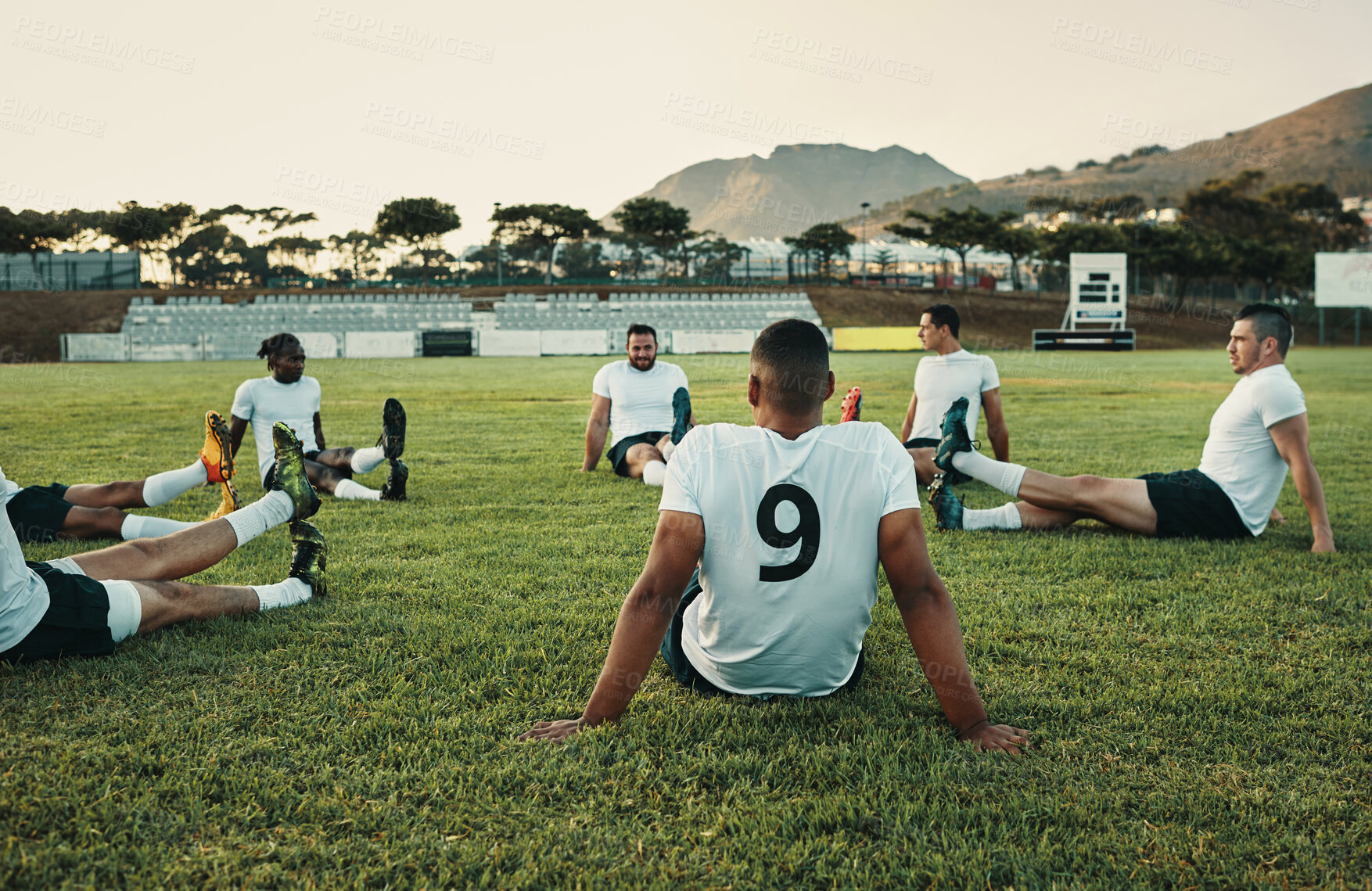 Buy stock photo Cropped shot of a group of young rugby players training on the field during the day