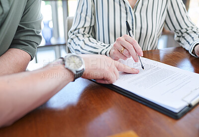 Buy stock photo Closeup shot of two unrecognisable businesspeople going through paperwork together in an office