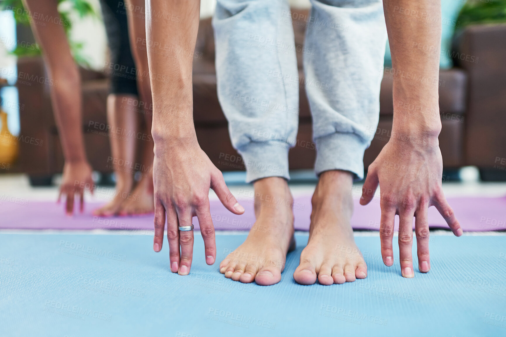 Buy stock photo Cropped shot of an unrecognizable couple practising yoga at home