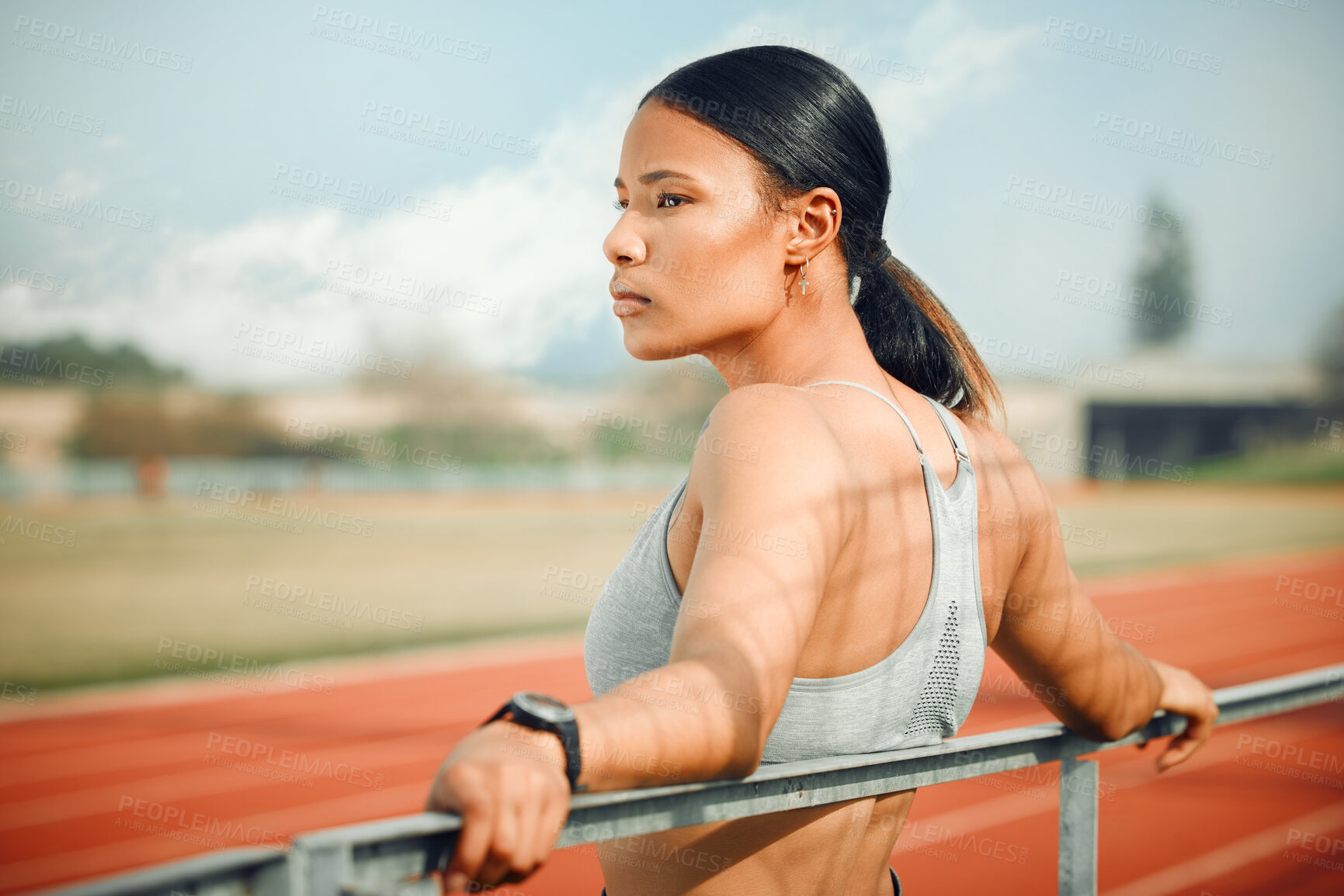 Buy stock photo Cropped shot of an attractive young female athlete taking a break while exercising outdoors