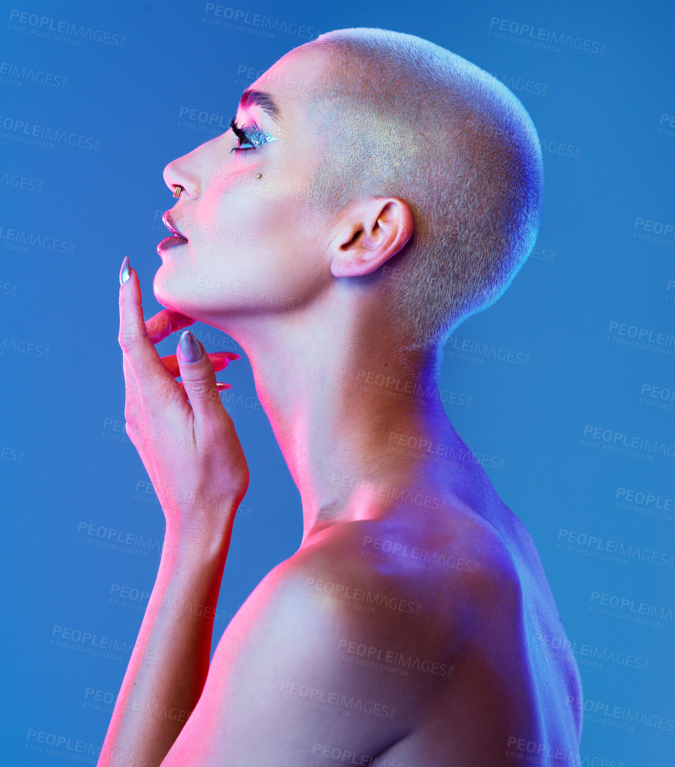 Buy stock photo Studio shot of an attractive young woman wearing edgy makeup against a blue background