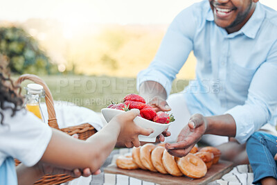 Buy stock photo Strawberry, hands and picnic with family in park for food, bonding and summer vacation. Happiness, love and care with people eating on field in nature for health, holiday event and lunch together