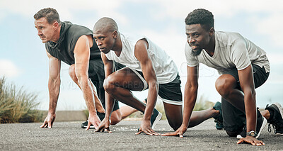 Buy stock photo Shot of a group of men getting ready to start a race