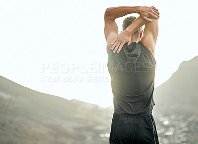 Buy stock photo Shot of an unrecognizable man stretching before a run