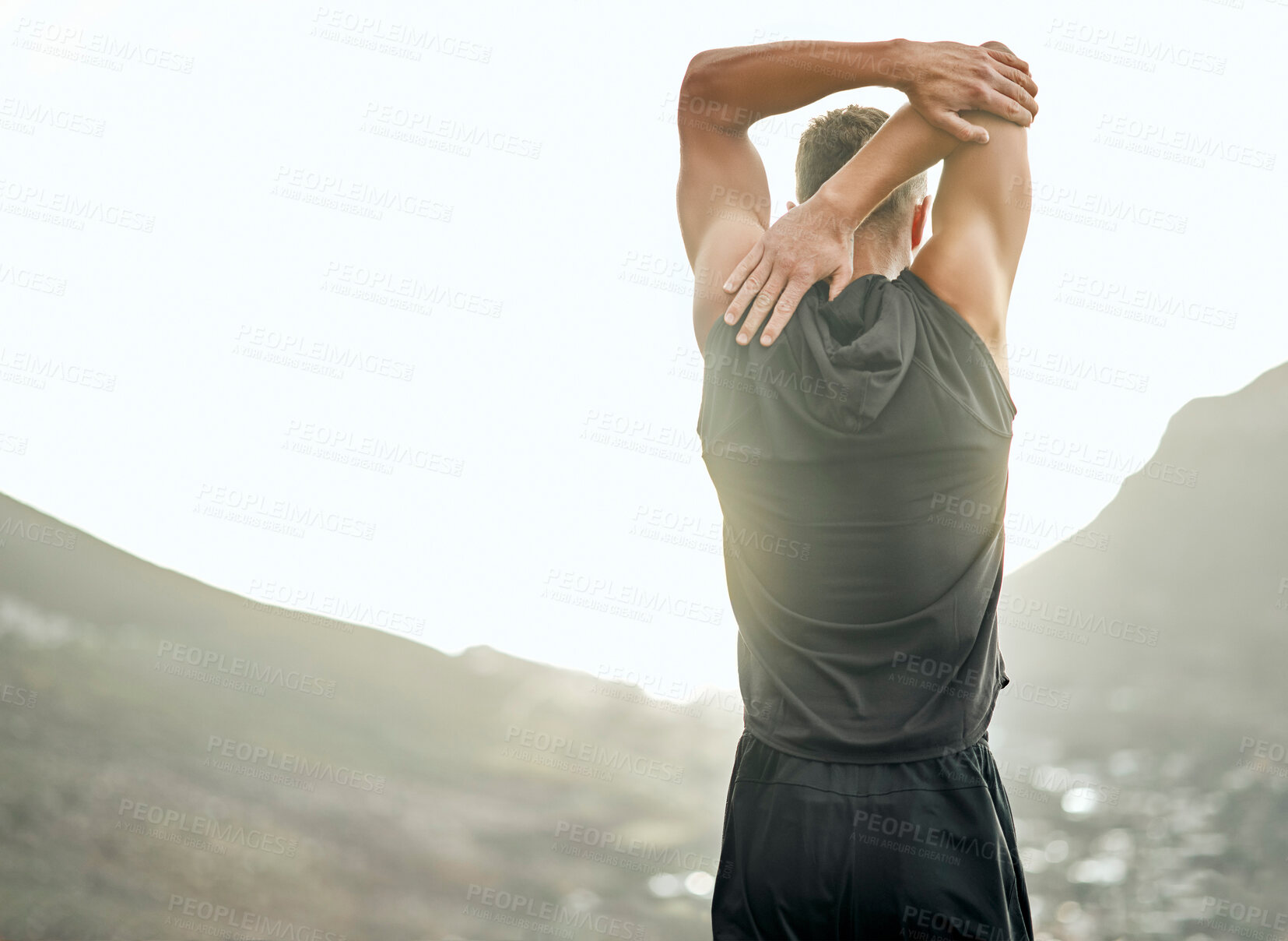 Buy stock photo Shot of an unrecognizable man stretching before a run