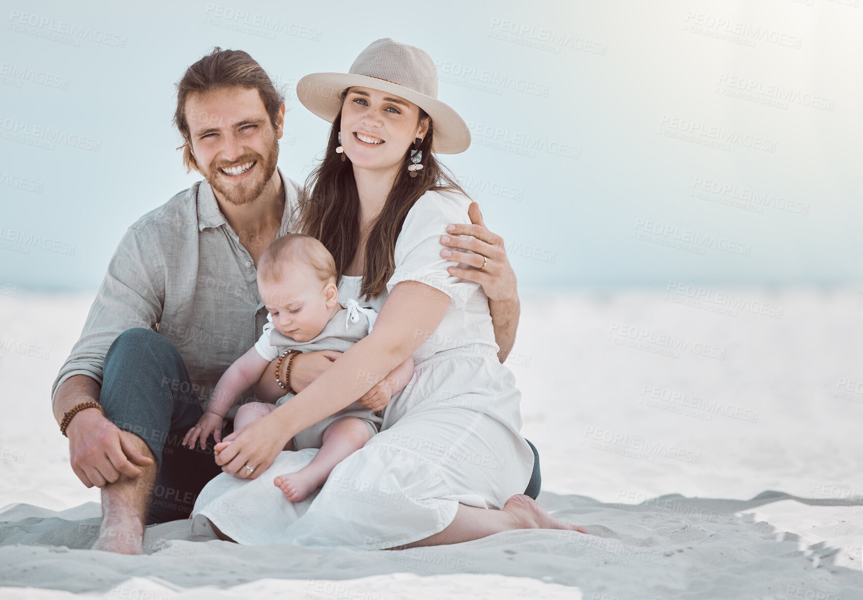 Buy stock photo Parents, baby and smile in portrait at beach, relax and together on ground for play, care and vacation. Mother, father and infant boy on sand with connection, love and outdoor with sunshine in Italy