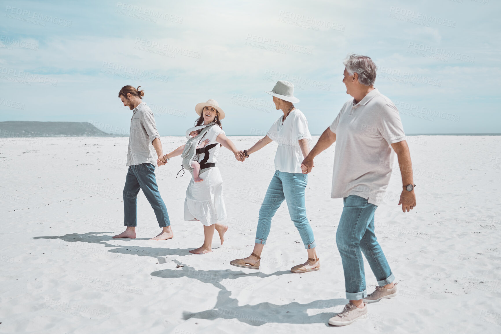 Buy stock photo Generations, family and holding hands on beach with travel, smile and bonding on holiday together. Grandparents, parents and baby on ocean vacation with happy people on outdoor adventure in Australia