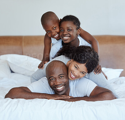 Buy stock photo Portrait, stack and black family with love, bedroom and bonding together with happiness. Africa parents, mother and father with children, kids and smile with morning fun, game and playing in house