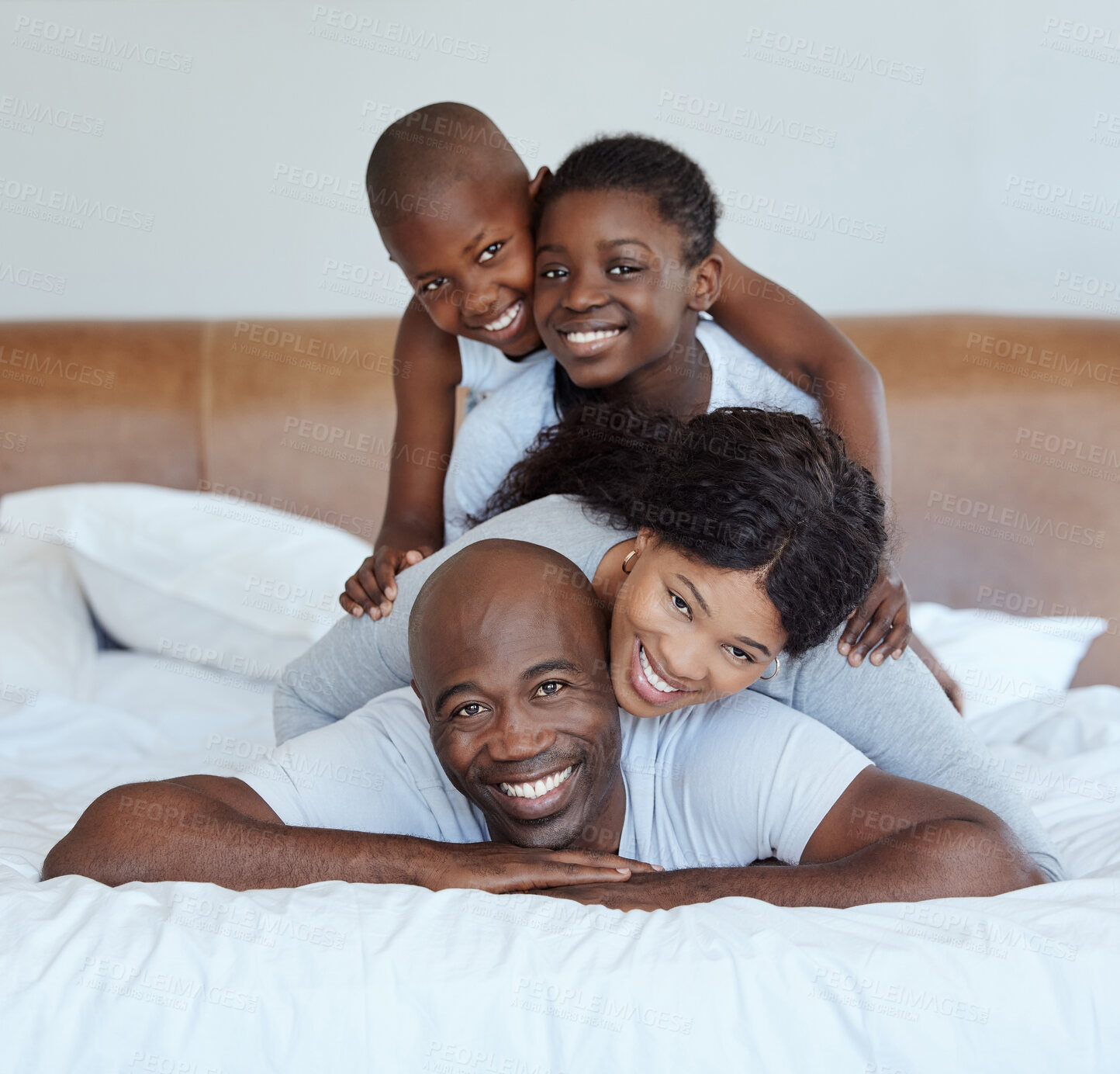 Buy stock photo Portrait, stack and black family with love, bedroom and bonding together with happiness. Africa parents, mother and father with children, kids and smile with morning fun, game and playing in house