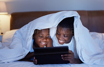 Buy stock photo Black family, night and girl with boy, tablet and playing with blanket, typing and online game. African kids, children and siblings in house, tech and internet with digital app, ebook or social media