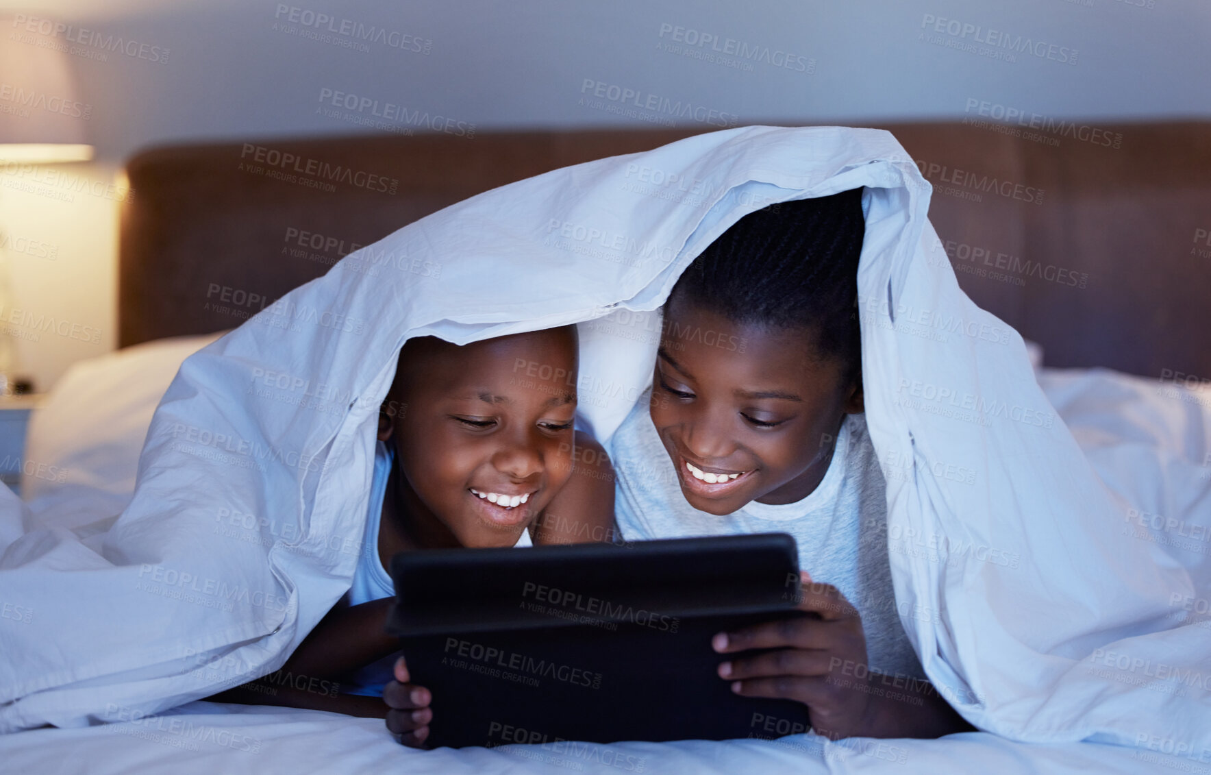 Buy stock photo Black family, night and girl with boy, tablet and playing with blanket, typing and online game. African kids, children and siblings in house, tech and internet with digital app, ebook or social media