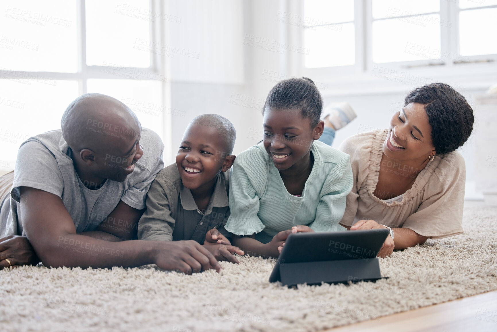 Buy stock photo African family, smile and relax with tablet on floor in home for learning, meme or funny conversation. Mother, father and kids on carpet with technology for streaming cartoon, movie or people laugh