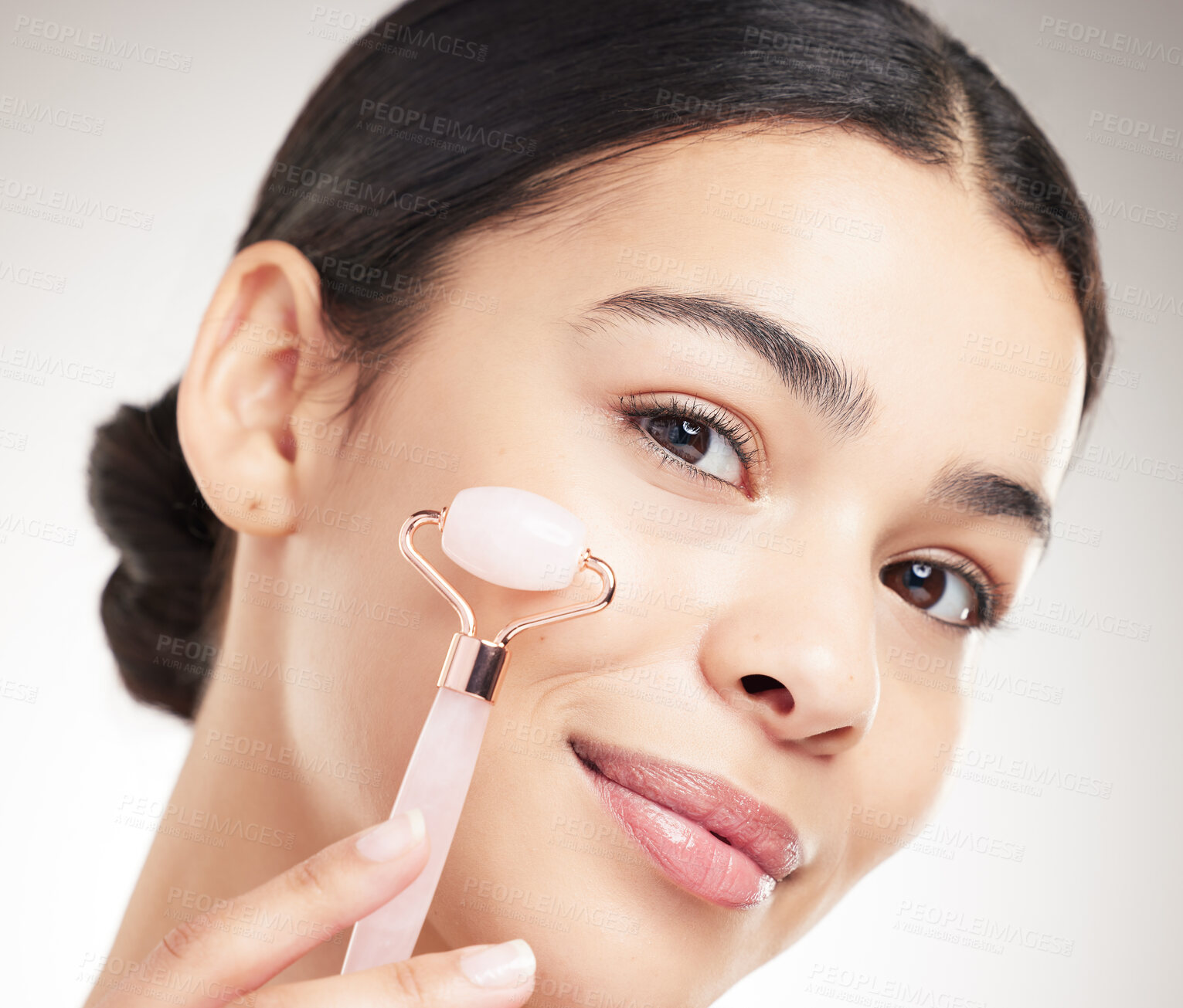 Buy stock photo Beauty, skincare and portrait of woman with roller for results, glow and anti aging on gray studio background. Face, rose quartz and model with stone for dermatology treatment, cosmetics or massage