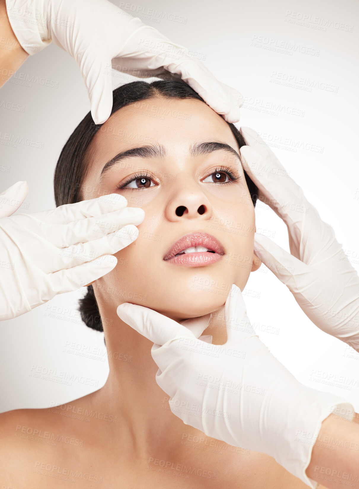 Buy stock photo Gloves, hands and woman for plastic surgery in studio with facial check, rhinoplasty and medical transformation. Girl, surgeon and reconstruction with aesthetic, filler procedure and white background