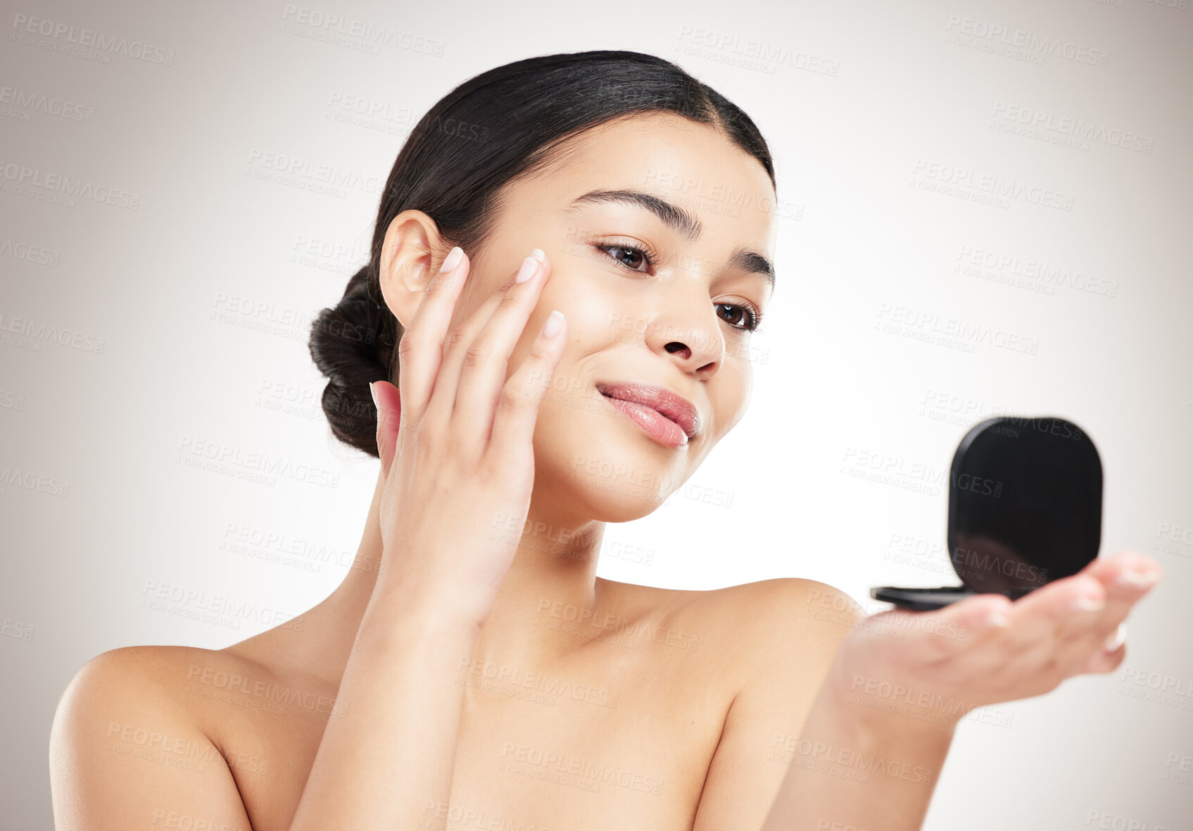 Buy stock photo Makeup, skincare and woman with mirror for face check, beauty search and inspection for satisfaction. Smile, wellness and model touching facial skin for health isolated on gray studio background