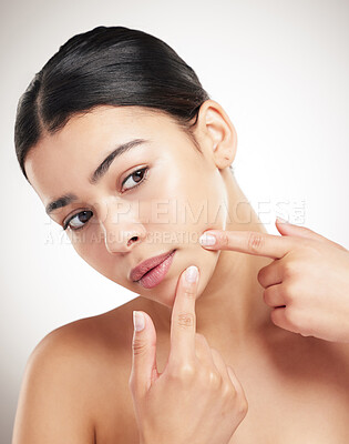 Buy stock photo Beauty, woman and press pimple in studio for skincare breakout, acne anxiety and dermatology treatment. Girl, pop and facial allergy for bacteria stress, dry skin and scar disaster on gray background