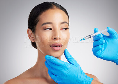 Buy stock photo A gorgeous mixed race young woman getting derma filler. Hispanic model getting cosmetic surgery against a grey copyspace background