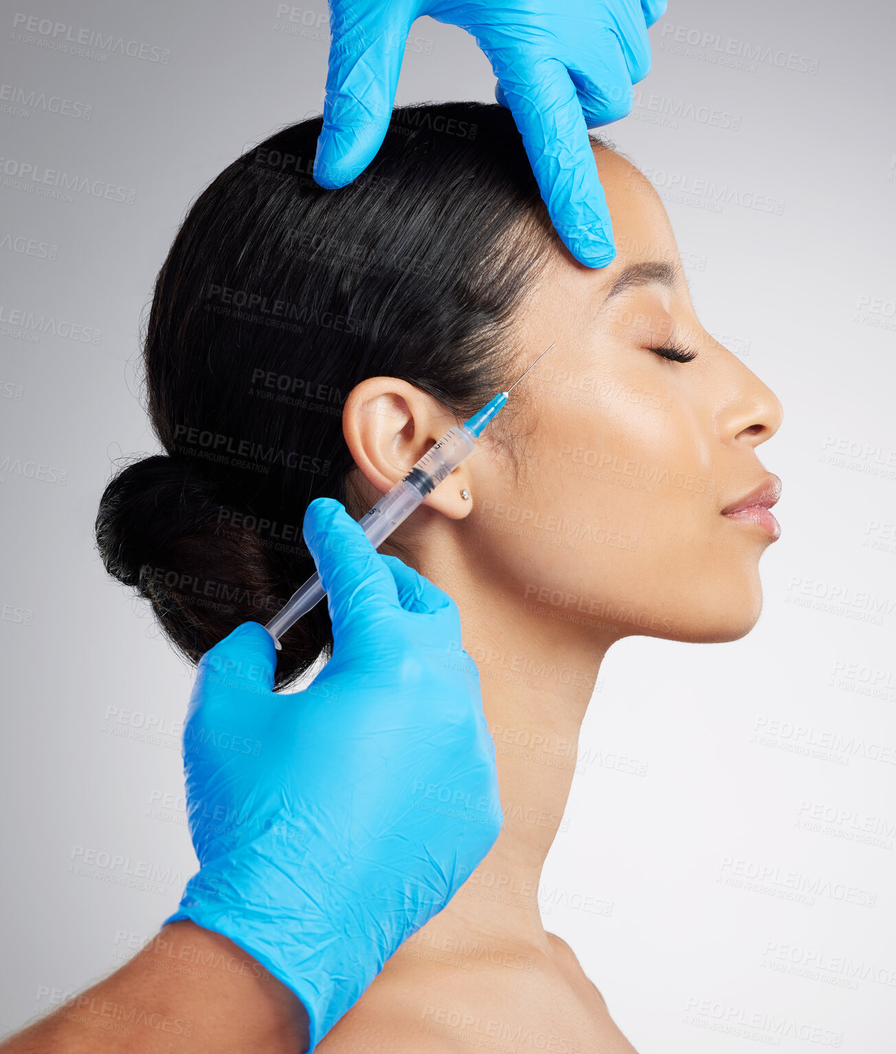 Buy stock photo Closeup of a gorgeous mixed race woman getting derma filler. Hispanic model getting filler to reduce wrinkles against a grey copyspace background in a studio