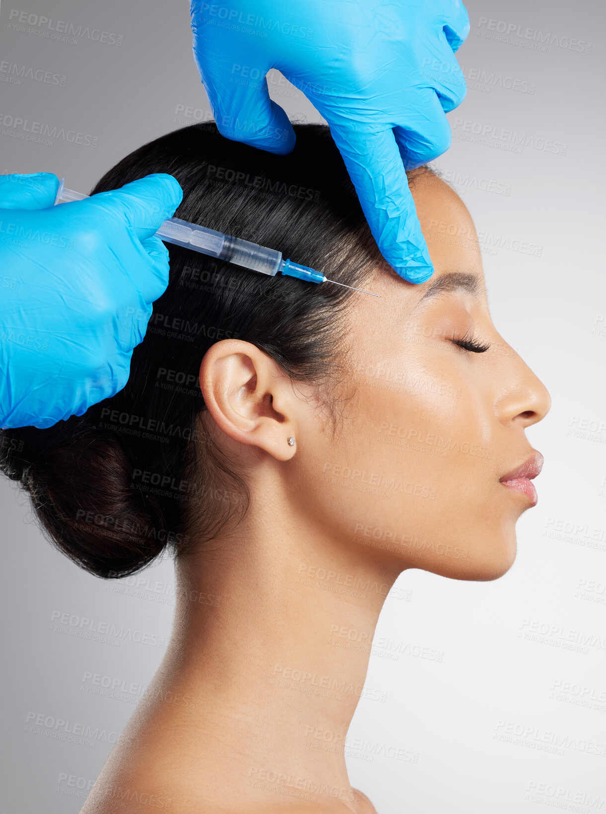 Buy stock photo Closeup of a gorgeous mixed race woman getting derma filler. Hispanic model getting filler to reduce wrinkles against a grey copyspace background in a studio