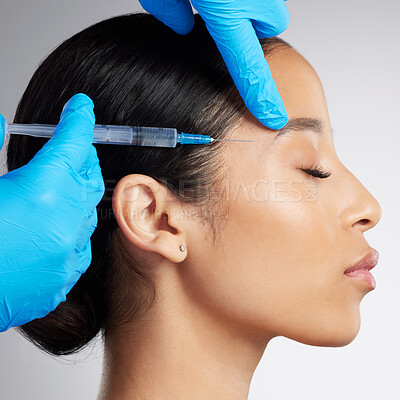 Buy stock photo Closeup of a gorgeous mixed race woman getting derma filler. Hispanic model getting filler to reduce wrinkles against a grey copyspace background in a studio