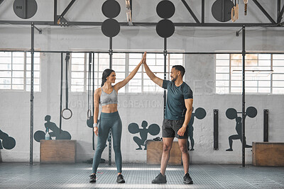 Buy stock photo Fit, active and healthy sports athletes training together in gym workout room, living a strong wellness lifestyle. Male and female fitness instructors high five and smiles in physical exercise class