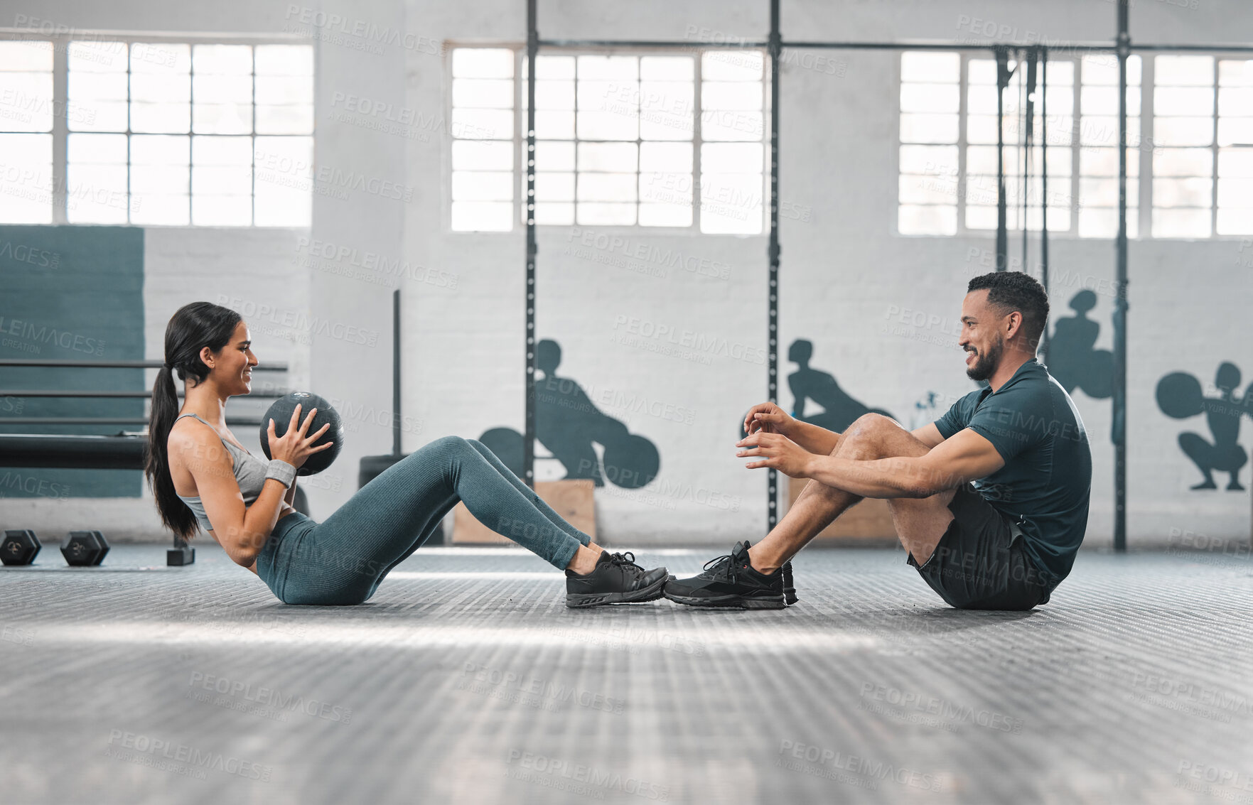 Buy stock photo Active, sporty fitness couple or gym partners training together, doing core exercises with heavy equipment. Male trainer and female athlete having a fun workout session or class to build strength