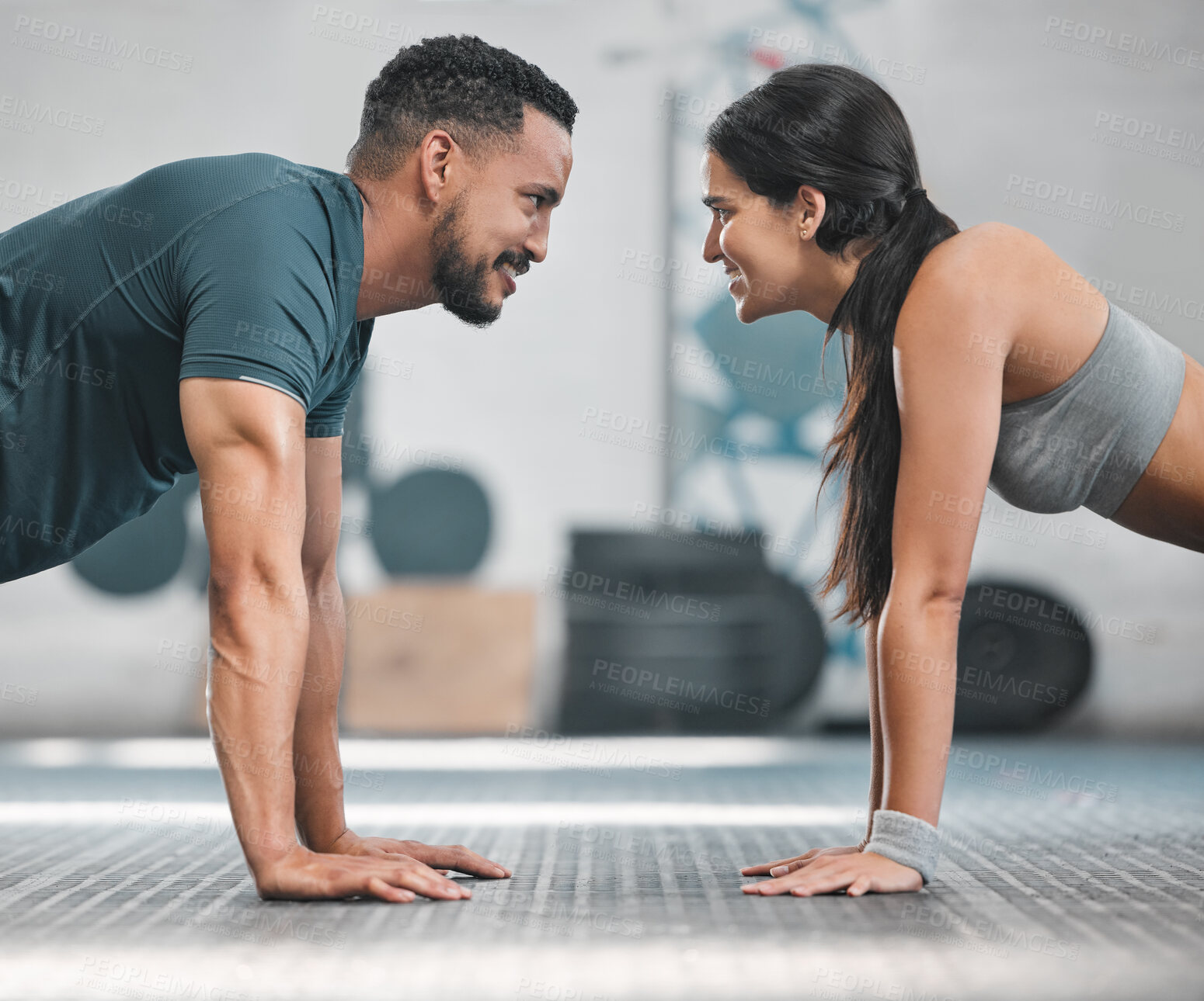 Buy stock photo Fitness, health and active couple training together in a gym doing exercise workout for healthy lifestyle. Young and focused athletic friends doing pushups indoor. Good teamwork for wellness goals