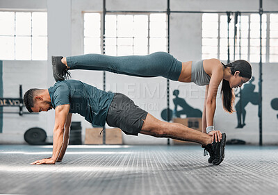 Buy stock photo Strength, active and fit couple exercising, training or doing workout exercise routine inside gym or sports center. Athletic, fitness man and woman balancing together in a physical endurance session