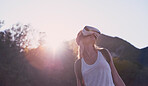 Woman hiking in a forest using a virtual reality headset to enhance the scenic nature. Woman using a virtual reality headset to escape to the metaverse during a hike in a forest on holiday