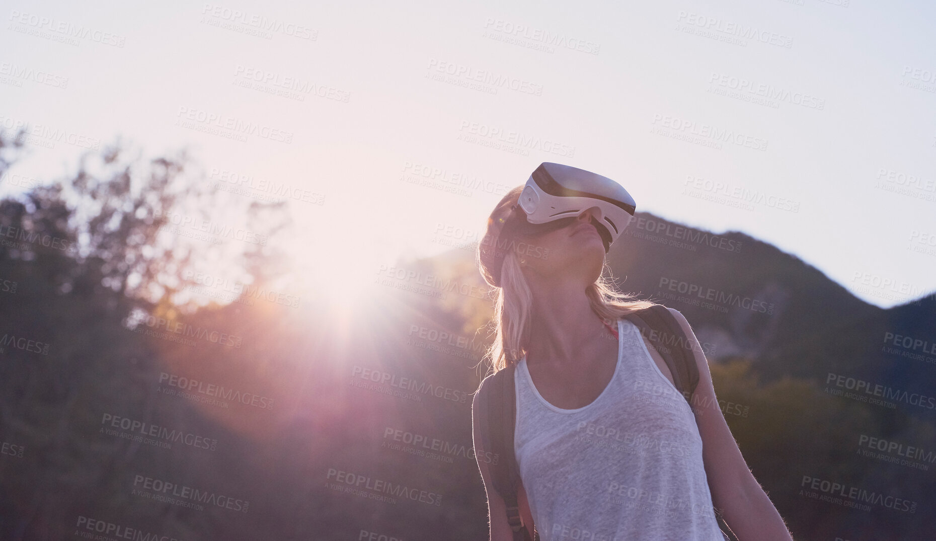 Buy stock photo Hiking, mountain and virtual reality with woman in nature for metaverse adventure, journey or travel. Earth, forest and sky with tourist person in VR headset for holiday or vacation from below