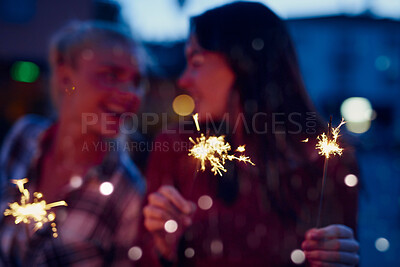 Buy stock photo Happy woman, friends and night with sparklers for celebration, new year or party together in city. Young, female person or women with fireworks in late evening for cheerful holiday or festive season