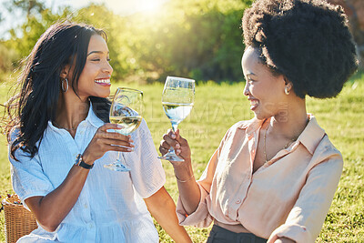 Buy stock photo Black woman, friends and toast in park at picnic with glass, drinks or champagne for happiness in sunshine. Women, happy and celebration in summer, relax and smile together at outdoor party on grass