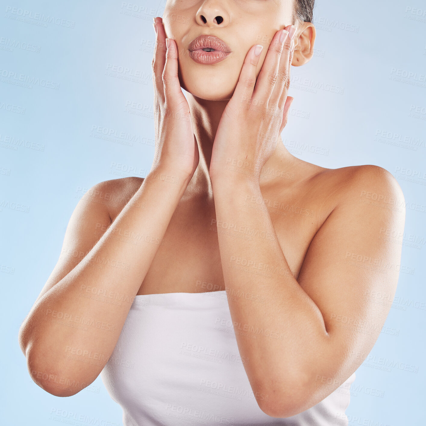 Buy stock photo Woman, lips and touch in studio for skincare, beauty and cosmetics with healthy skin, glow and texture. Model, mouth and hands on blue background for dermatology, aesthetic and facial transformation